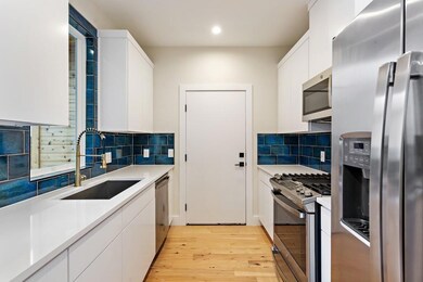 Kitchen with stainless steel appliances, white ca