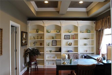 On the other side of the entry are the French doors which open into this fabulous office with coffer designed ceiling & recessed lighting, hardwood flooring, large window and beautiful built ins.  The door way to the left of this photos is the entrance into the jack-n-jill bath shared with bedroom #2.  This room could easily be converted to a 3rd bedroom on the main if needed as there is a large closet in the bathroom.