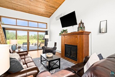 Living room featuring high vaulted ceiling, wooden