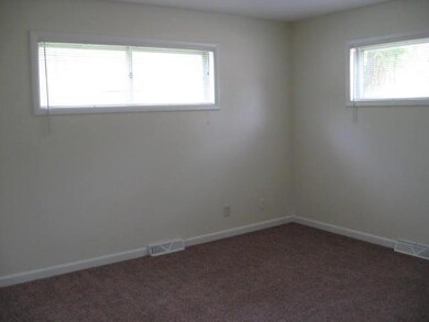 Large master bedroom with high windows allowing fo