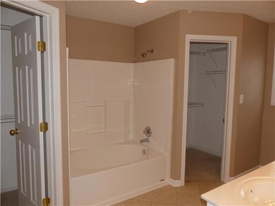 The master bathroom has double vanities and a large garden tub. 