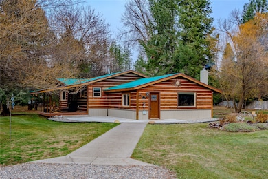 Log cabin featuring a front yard and a chimney