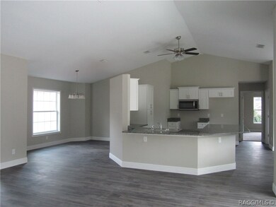View of kitchen and formal dining room from living