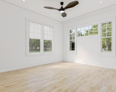 Spare room with wood finished floors, ceiling fan