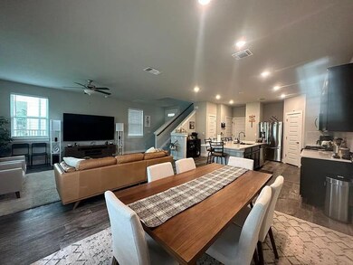 Dining room featuring ceiling fan, stairway, rece