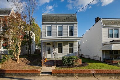View of property with covered porch and a front ya