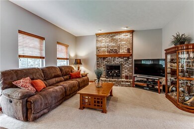 Family room sits off the kitchen and features a cozy gas fireplace.