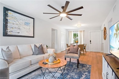 Living area featuring ceiling fan and light wood-type flooring