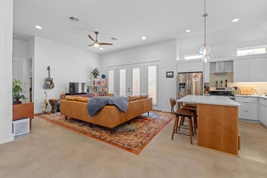 Living area with recessed lighting, finished conc