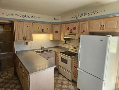 Kitchen featuring electric range oven, light brown