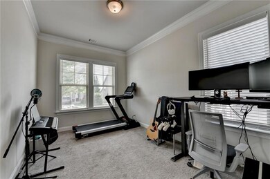Office space with carpet floors and crown molding