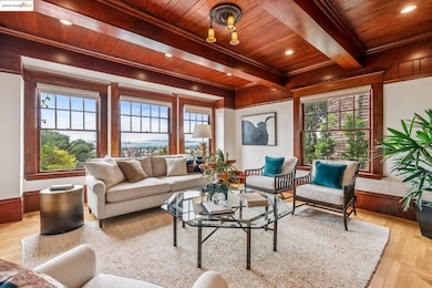 Living area with light wood finished floors, a wood ceiling with exposed beams, and recessed lighting
