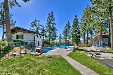 Community pool, hot tub, and lake view club house.