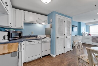 Kitchen featuring white cabinetry, sink, and white