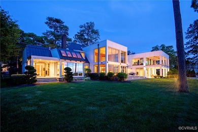 Back of property with a balcony, a chimney, a stan