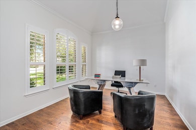 Home office featuring ornamental molding and wood