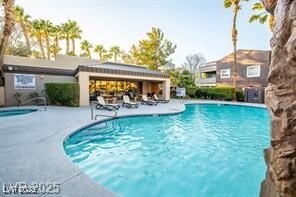 Community pool featuring a patio