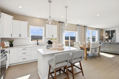 (Photos of model home, finishes will vary) The center island doubles as a breakfast bar, ready for casual meals and entertaining