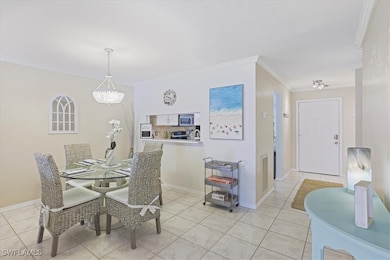 Dining space featuring crown molding, light tile p