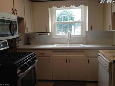 The kitchen has painted white cabinets.  All appli