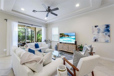 Tiled living room with ceiling fan, crown molding,
