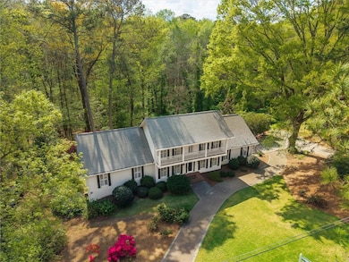Aerial view featuring a wooded view