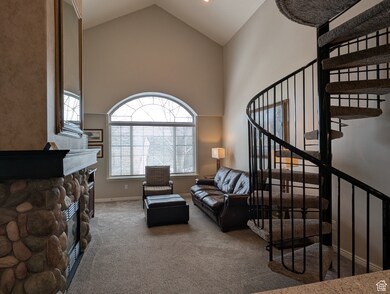 Living room featuring carpet flooring, a fireplace, and high vaulted ceiling
