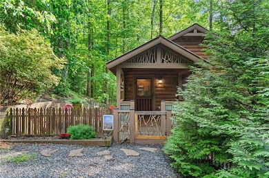 View of outbuilding with a gate and a view of trees