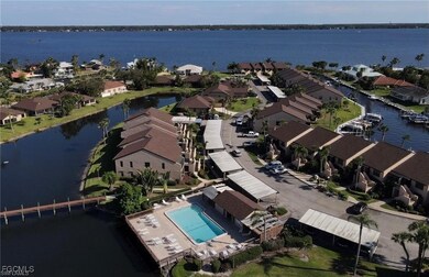 Aerial perspective of suburban area with a nearby body of water and a pool area