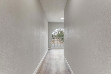 Corridor with baseboards, wood finished floors, an