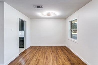 Dining room features a designer light fixture.