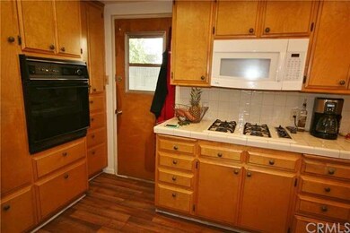 Kitchen, showing oven and door to backyard