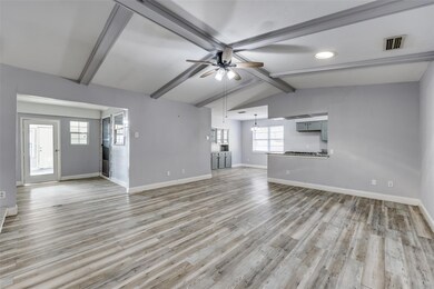 Unfurnished living room featuring lofted ceiling w