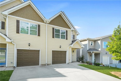 View of front of property with an attached garage and concrete driveway