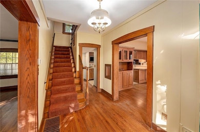 The entry way with a view of the built-in hutch in the dining room.