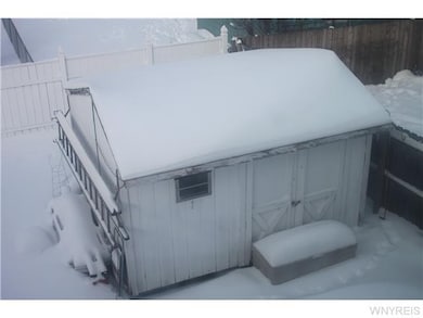 Exterior Back. Fenced yard, door in back to baseme