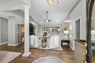 Living room featuring vaulted ceiling, dark hardwo