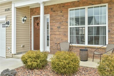 Welcome! Covered front porch with stone accent wall is a great spot to enjoy the evening sunsets