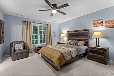Carpeted bedroom featuring baseboards and ceiling
