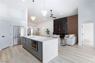 Kitchen featuring a center island with sink, stain