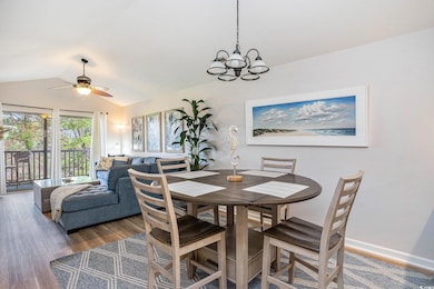 Dining space featuring vaulted ceiling, wood finis