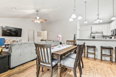 Dining space with vaulted ceiling, ceiling fan, an