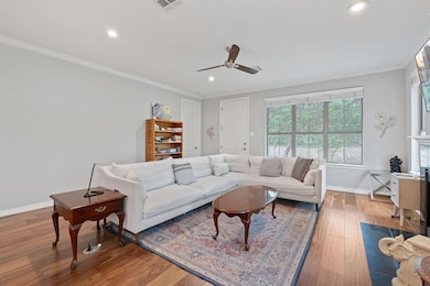 Living area with a ceiling fan, recessed lighting