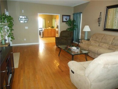 Very nice picture of the living room so welcoming looking into the kitchen.