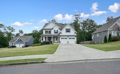 View of front of property with driveway, a front yard, and a garage