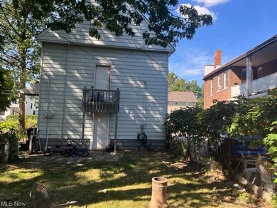 Rear view of property featuring a lawn