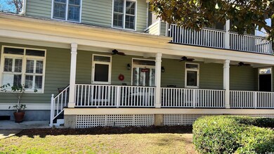 Doorway to property with covered porch and ceiling