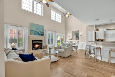 Living area featuring a towering ceiling, a wainsc