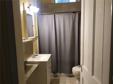 Full bathroom with tile patterned floors, toilet, 