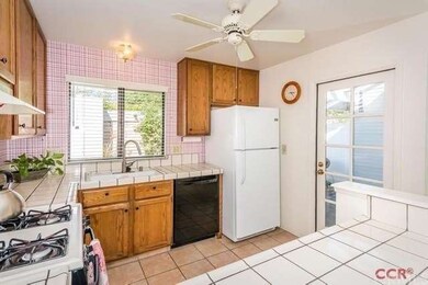 Bright kitchen with garden door leading to rear pa